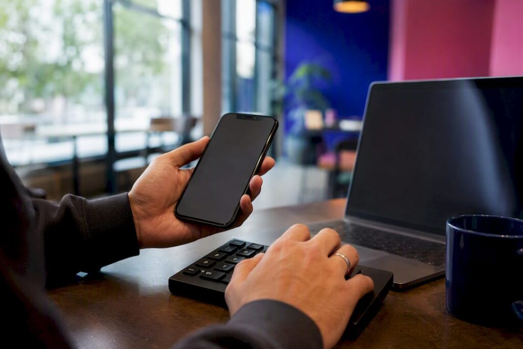 Des mains composent un code sur un terminal de paiement.